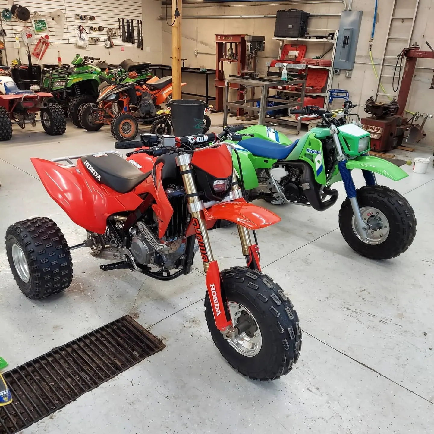 Classic red and green three-wheelers in the shop