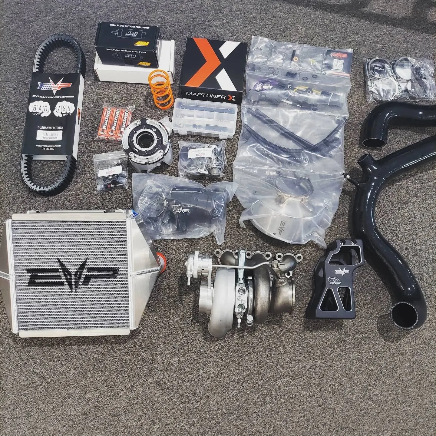 Evolution Powersports turbo kit laid out before an install