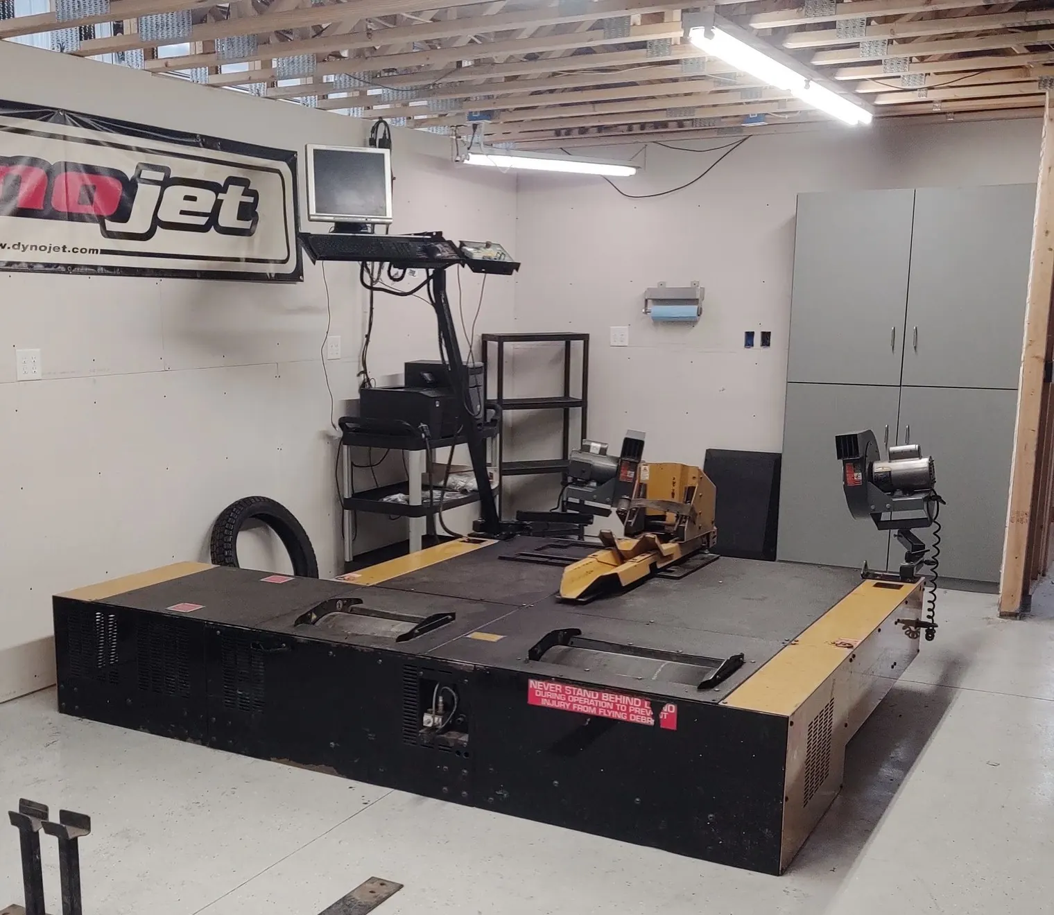 Dynojet dyno cell with roller platform, Dynojet banner and tuning computer