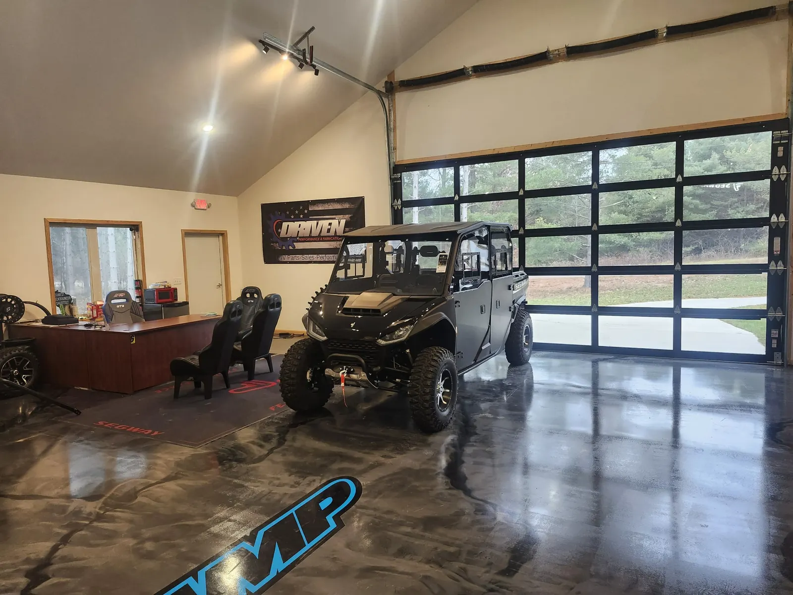 Crew-cab side-by-side parked by the sales desk