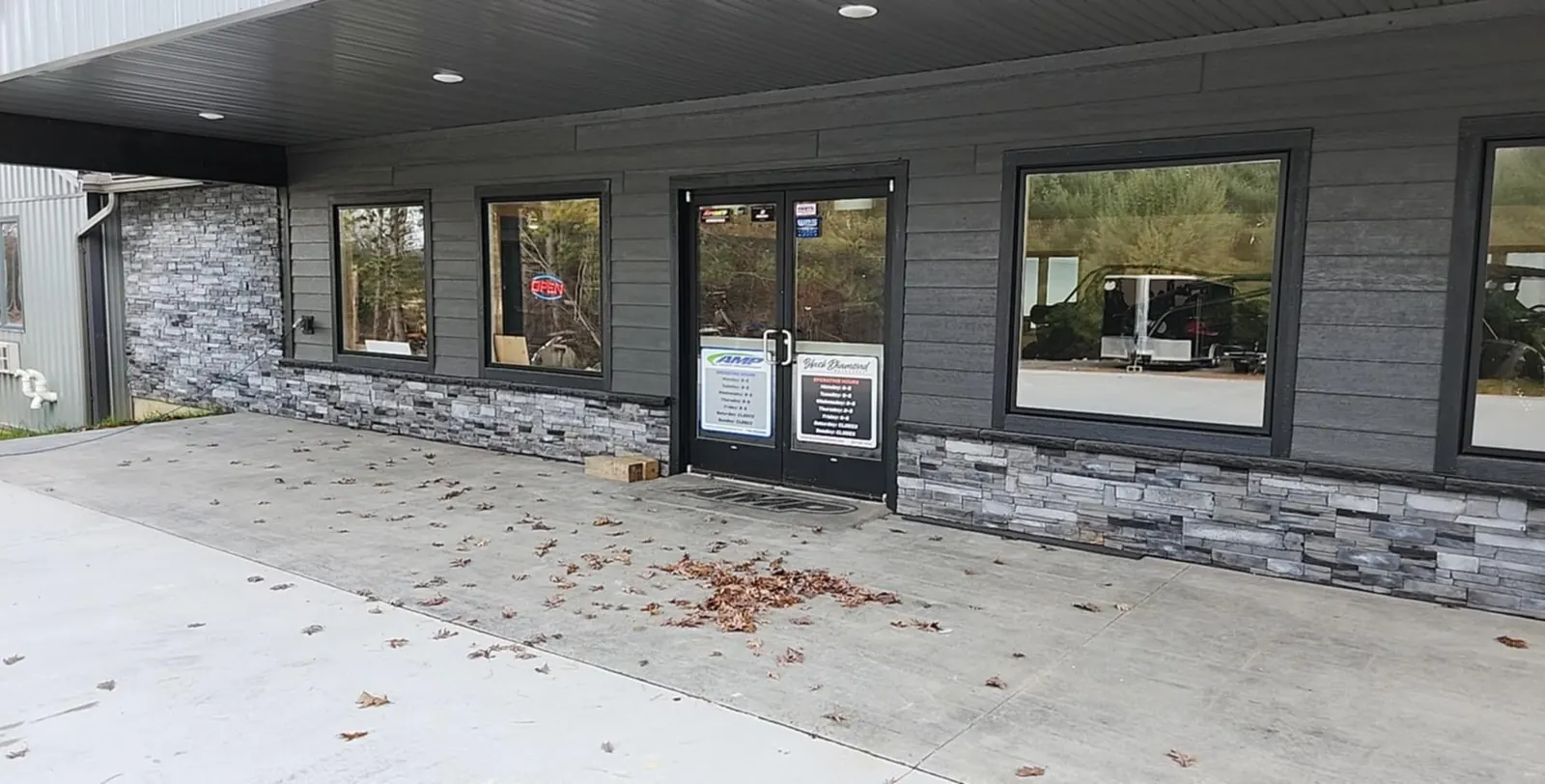 Front entrance with stone accents and showroom windows